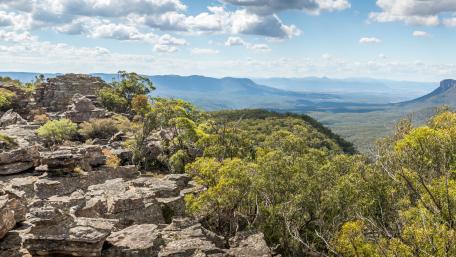 Majestic Mountain Landscape with Lush Greenery and Cloudy Sky wallpaper