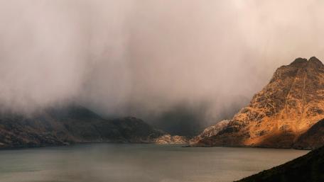 Misty Mountains Over Calm Waters wallpaper