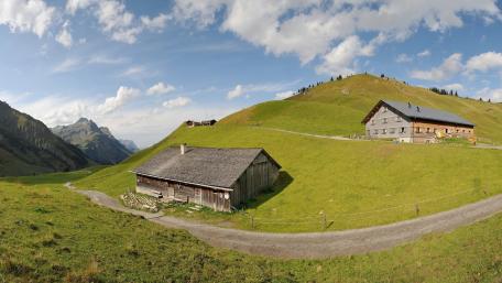 Serene Alpine Landscape with Charming Cabins wallpaper