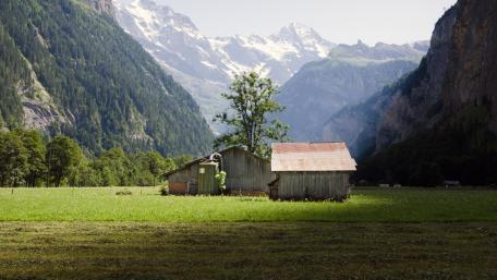 Tranquil Mountain Landscape with Rustic Barns wallpaper