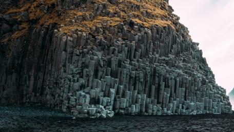 Majestic Rocky Cliff in Serene Landscape wallpaper