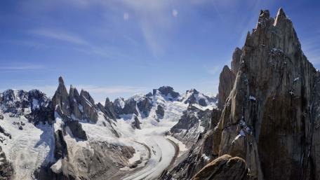 Majestic Snow-Capped Peaks Under Blue Sky wallpaper