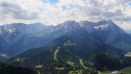 Majestic Mountain Peaks Under a Cloudy Sky wallpaper