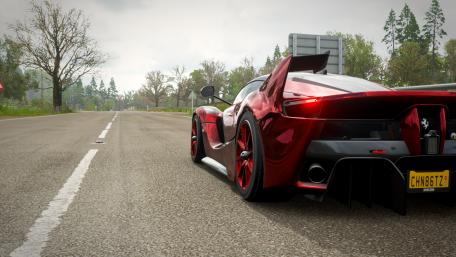 Sleek Supercar on Open Road wallpaper