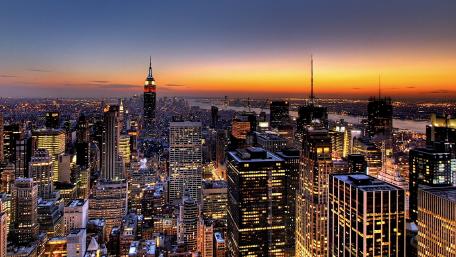 Cityscape at Dusk with Skyscrapers and Sunset Glow wallpaper