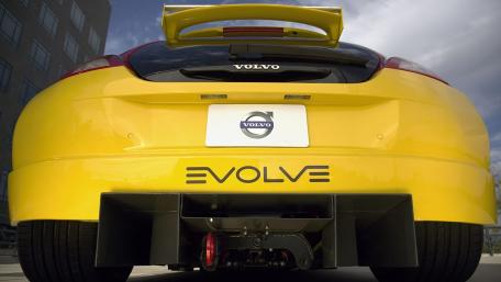 Sleek Yellow Car with Evolve Branding wallpaper