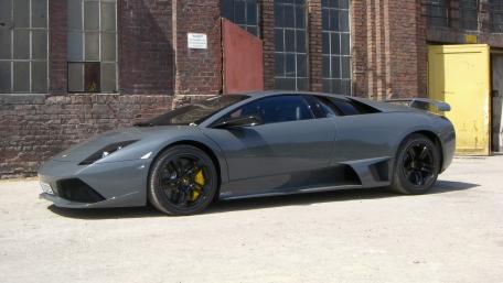 Sleek Gray Supercar in Urban Setting wallpaper