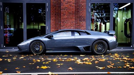 Sleek Gray Supercar Under Urban Lights wallpaper