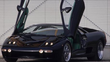 Sleek Black Sports Car with Iconic Doors wallpaper