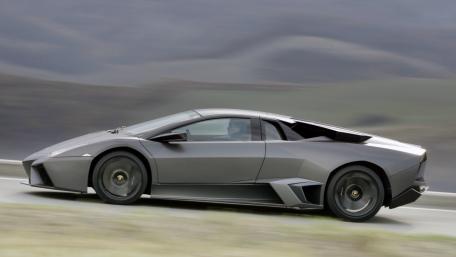 Sleek Black Supercar on the Open Road wallpaper