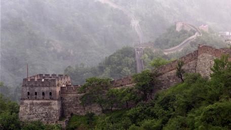 Ancient Walls Embraced by Misty Mountains wallpaper