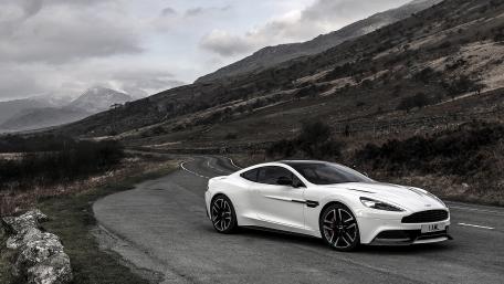 Sleek White Car on a Scenic Mountain Road wallpaper