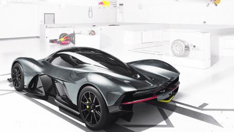 Sleek Aston Martin Hypercar in Modern Garage Setting wallpaper