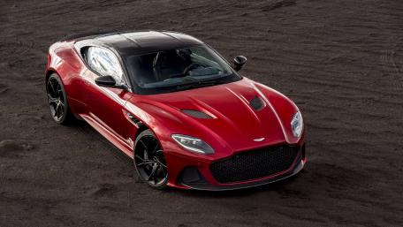 Sleek Red Sports Car in a Bold Landscape wallpaper