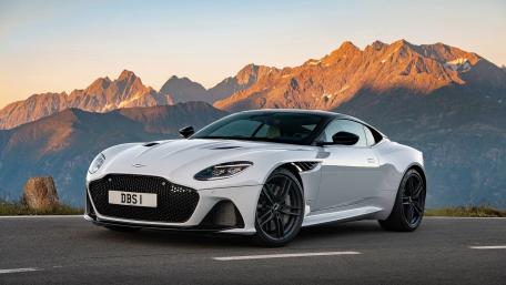 Sleek Aston Martin DBS Against Majestic Mountains wallpaper