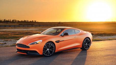 Vibrant Sunset with Sleek Orange Sports Car wallpaper