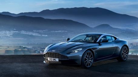 Sleek Aston Martin Against Majestic Mountainscape wallpaper