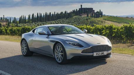 Sleek Aston Martin on Scenic Roadway wallpaper