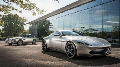 Sleek Luxury Cars in Modern Setting wallpaper