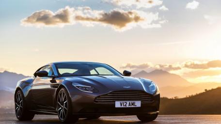 Sleek Aston Martin Against a Scenic Sunset wallpaper