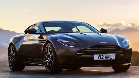 Sleek Aston Martin in a Scenic Sunset View wallpaper