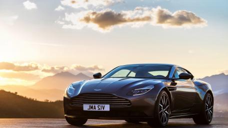 Sleek Aston Martin Against a Sunset Horizon wallpaper