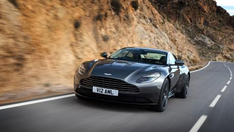 Sleek and Powerful Sports Car on Open Road wallpaper