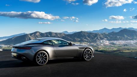 Sleek Aston Martin Against Majestic Mountains wallpaper