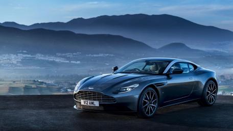 Sleek Aston Martin Against Majestic Mountains wallpaper