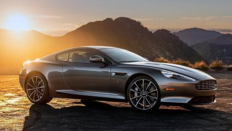 Elegant Aston Martin Against a Stunning Sunset Scene wallpaper