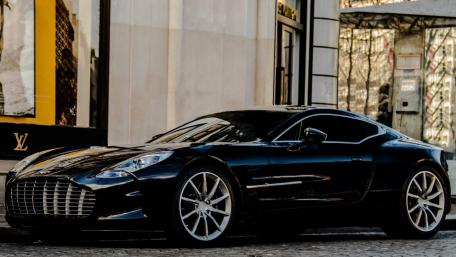 Sleek Black Sports Car in Urban Setting wallpaper