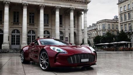 Elegant Red Sports Car in Urban Setting wallpaper