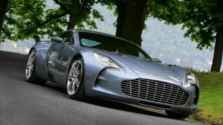 Sleek Aston Martin on Scenic Roadside View wallpaper