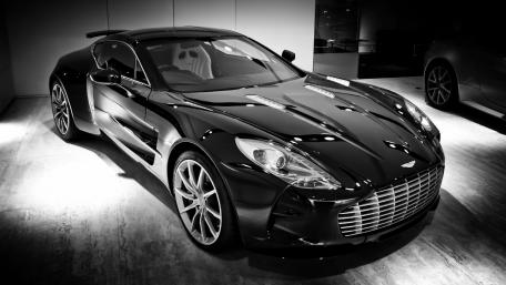 Sleek Black Aston Martin in Modern Showcase wallpaper