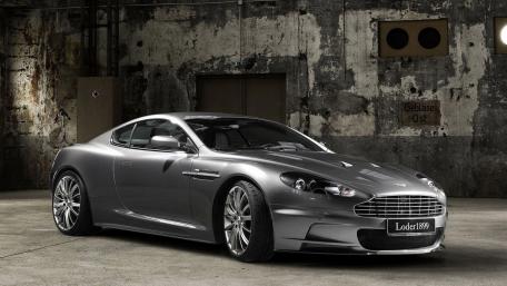 Sleek Aston Martin in Industrial Setting wallpaper