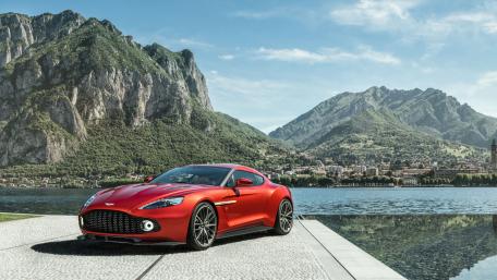 Sleek Red Sports Car Against Majestic Mountainside View wallpaper