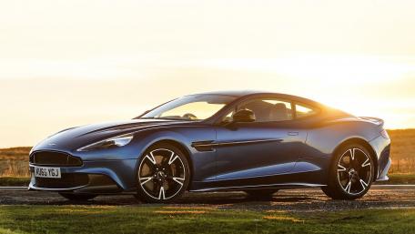 Sleek Blue Aston Martin Under Sunset Glow wallpaper