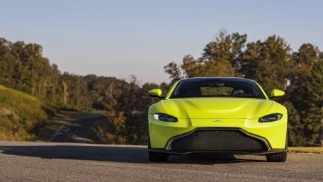 Vibrant Aston Martin on a Scenic Roadway wallpaper