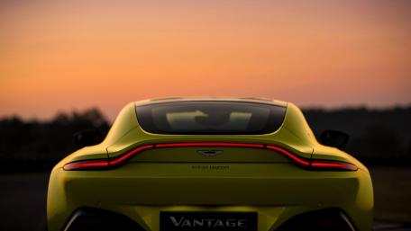 Vibrant Aston Martin at Sunset Scene wallpaper