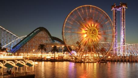 Vibrant Cityscape with Glowing Amusement Park Lights wallpaper