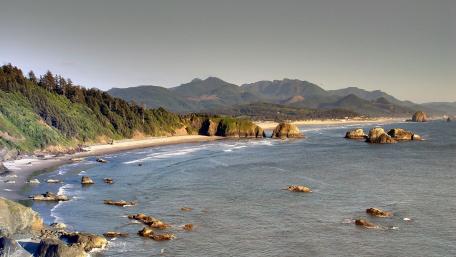 Serene Coastal Landscape with Mountain Backdrop wallpaper