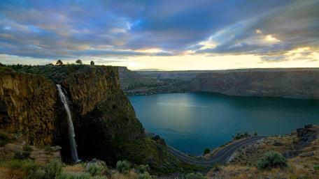 Majestic Waterfall Over Serene Lake Landscape wallpaper