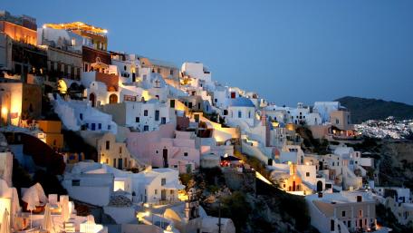 Enchanting Nightscape of Santorini's Whitewashed Homes wallpaper