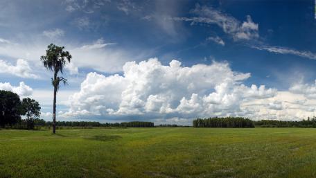 Serene Landscape Under Dramatic Clouds wallpaper