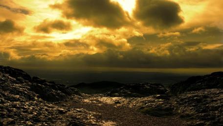Majestic Golden Dawn Over Rugged Mountains wallpaper