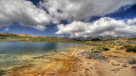 Serene Lake Under Vast Clouds wallpaper