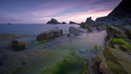 Serene Coastal Landscape with Boulders at Dusk wallpaper