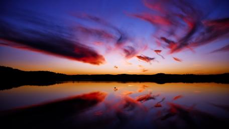 Serene Sunset Over a Tranquil Lake wallpaper