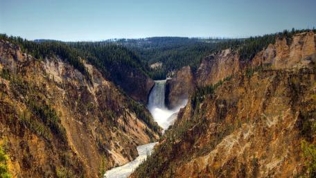 Majestic Falls Amidst Rugged Landscapes wallpaper