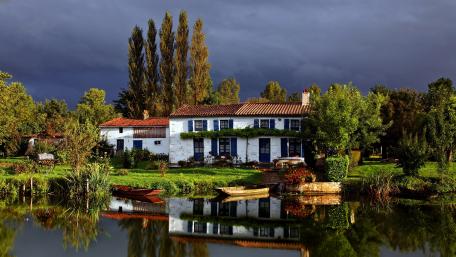 Charming Riverside Villa Amidst Lush Greenery wallpaper